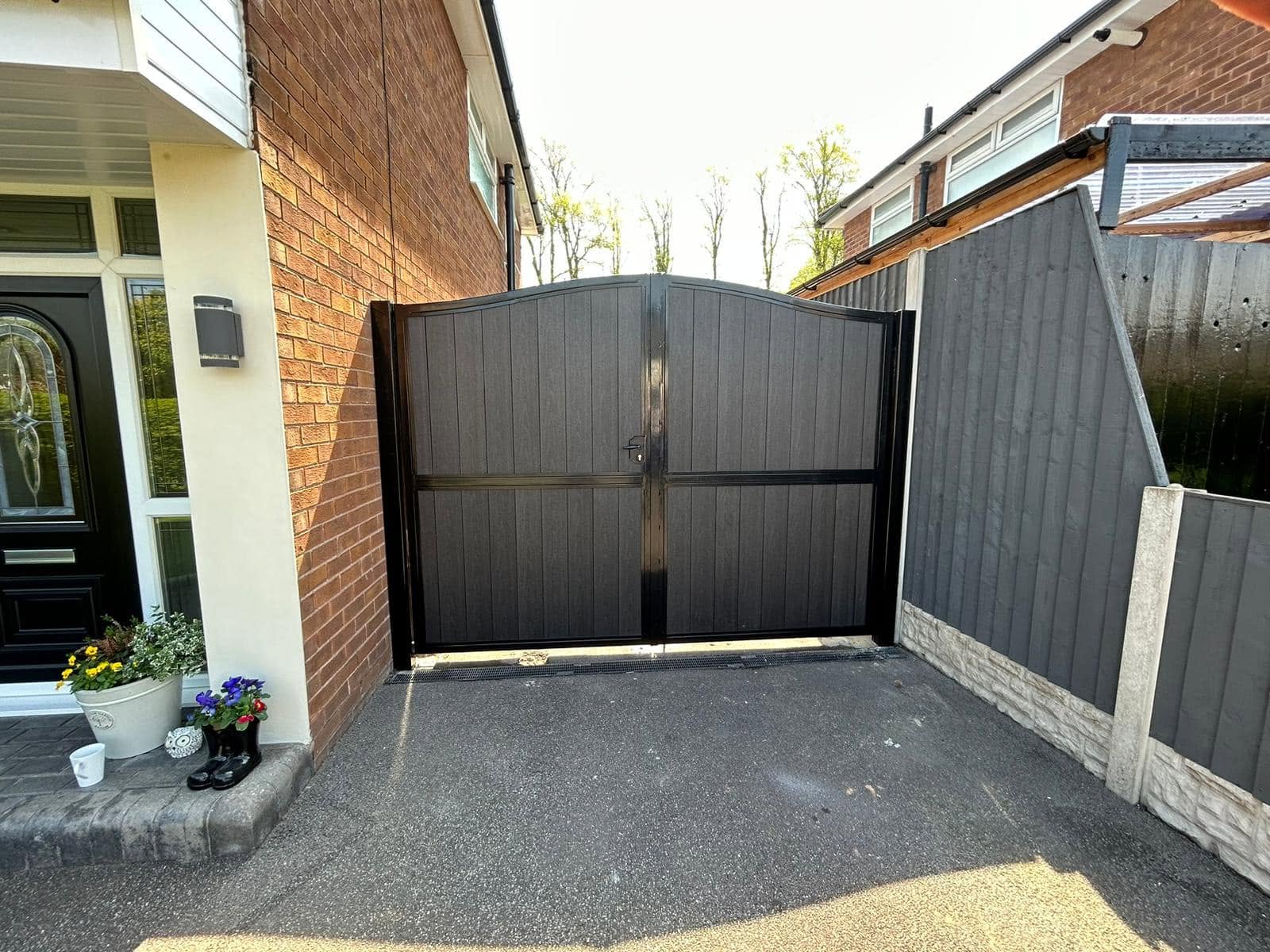 Arched black double gates with matching side panels