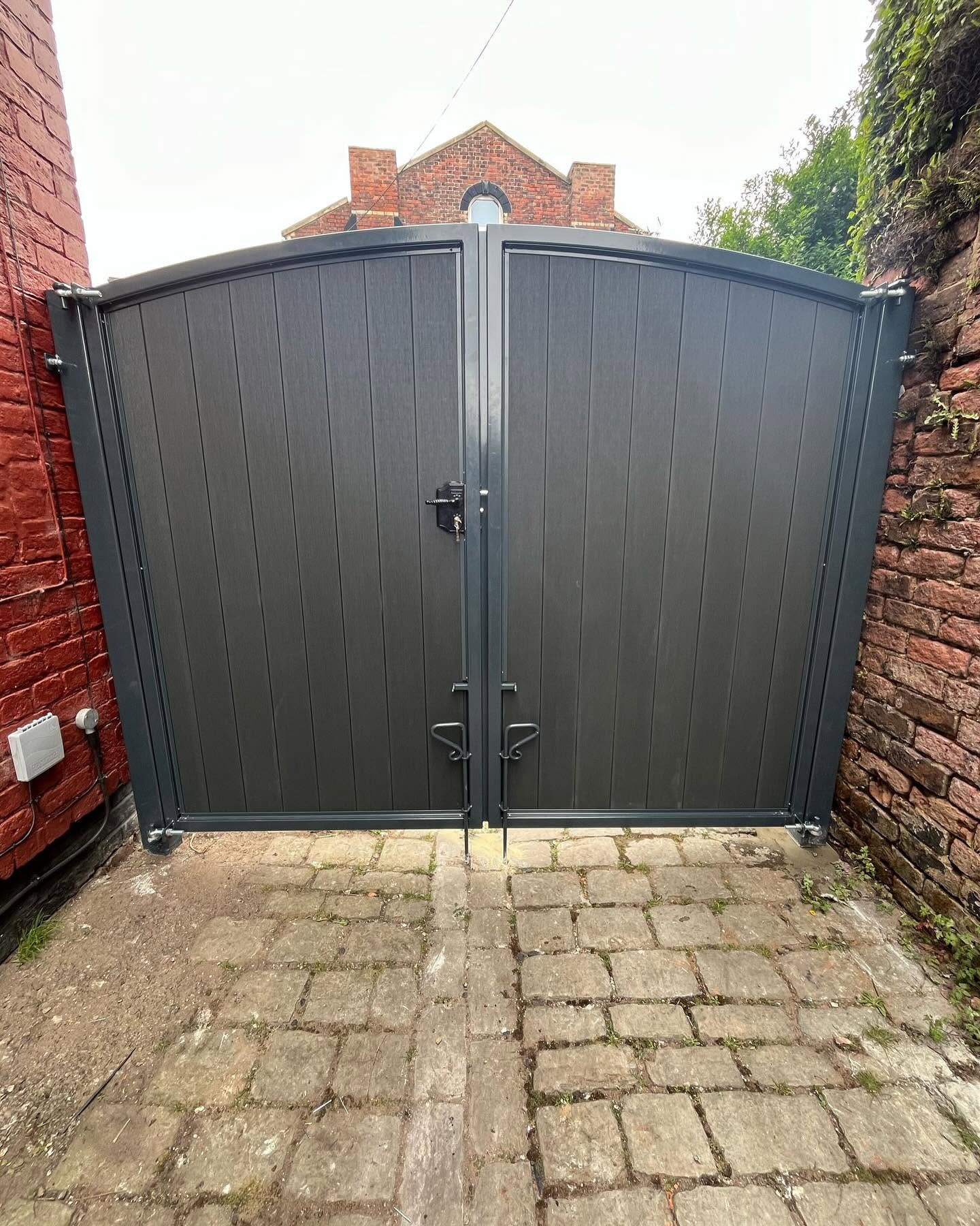 Secure double gates fitted to a brick-walled access
