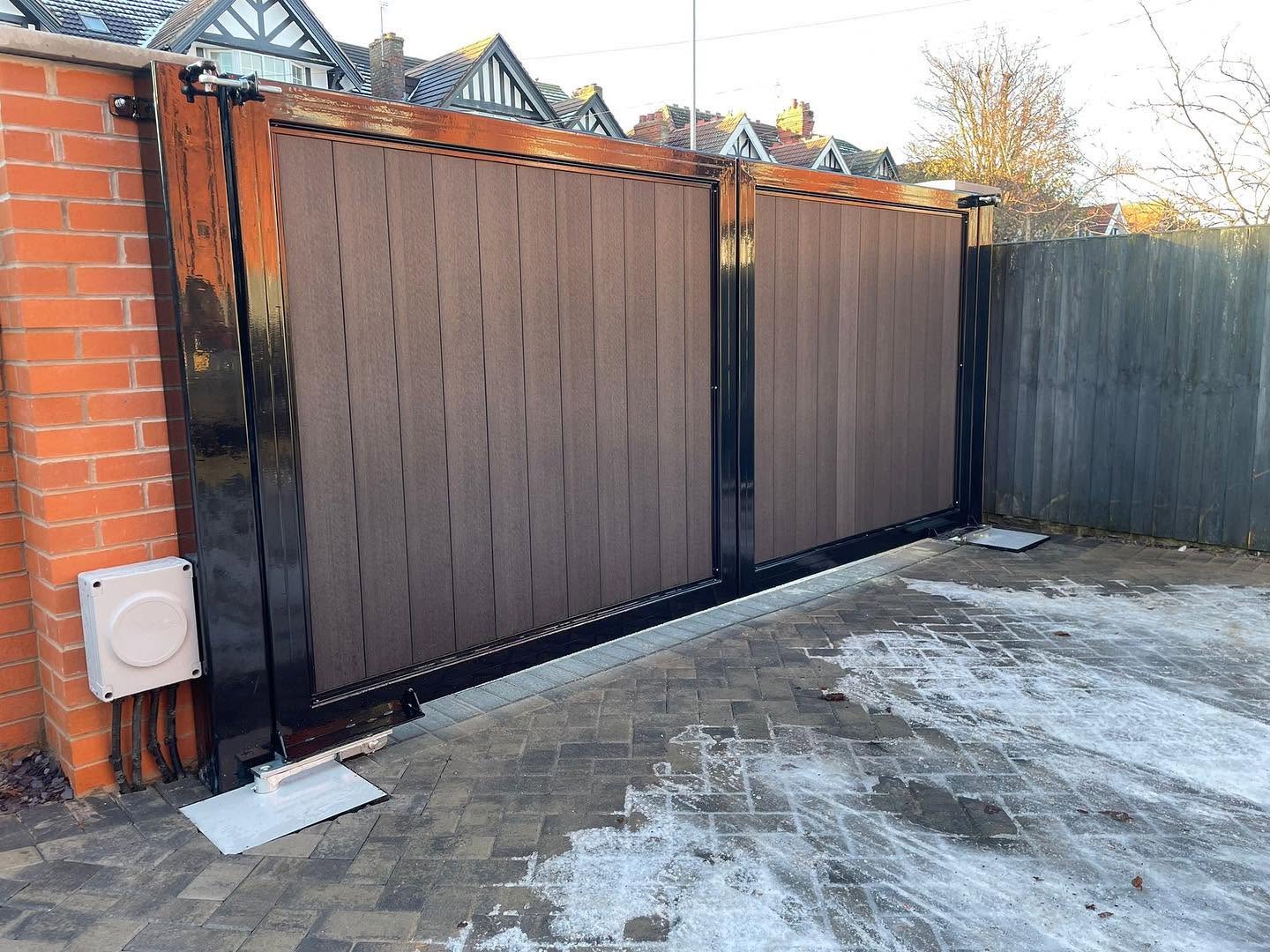 Brown composite double gates in a black fabricated frame