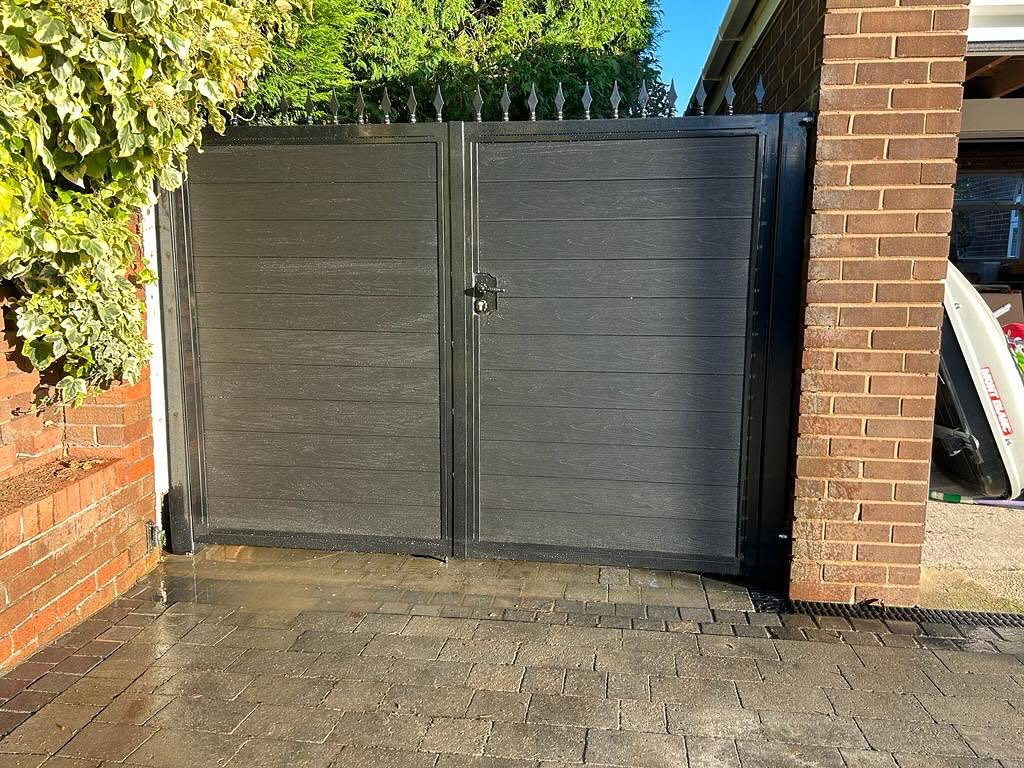 Grey composite double gates with a pedestrian leaf